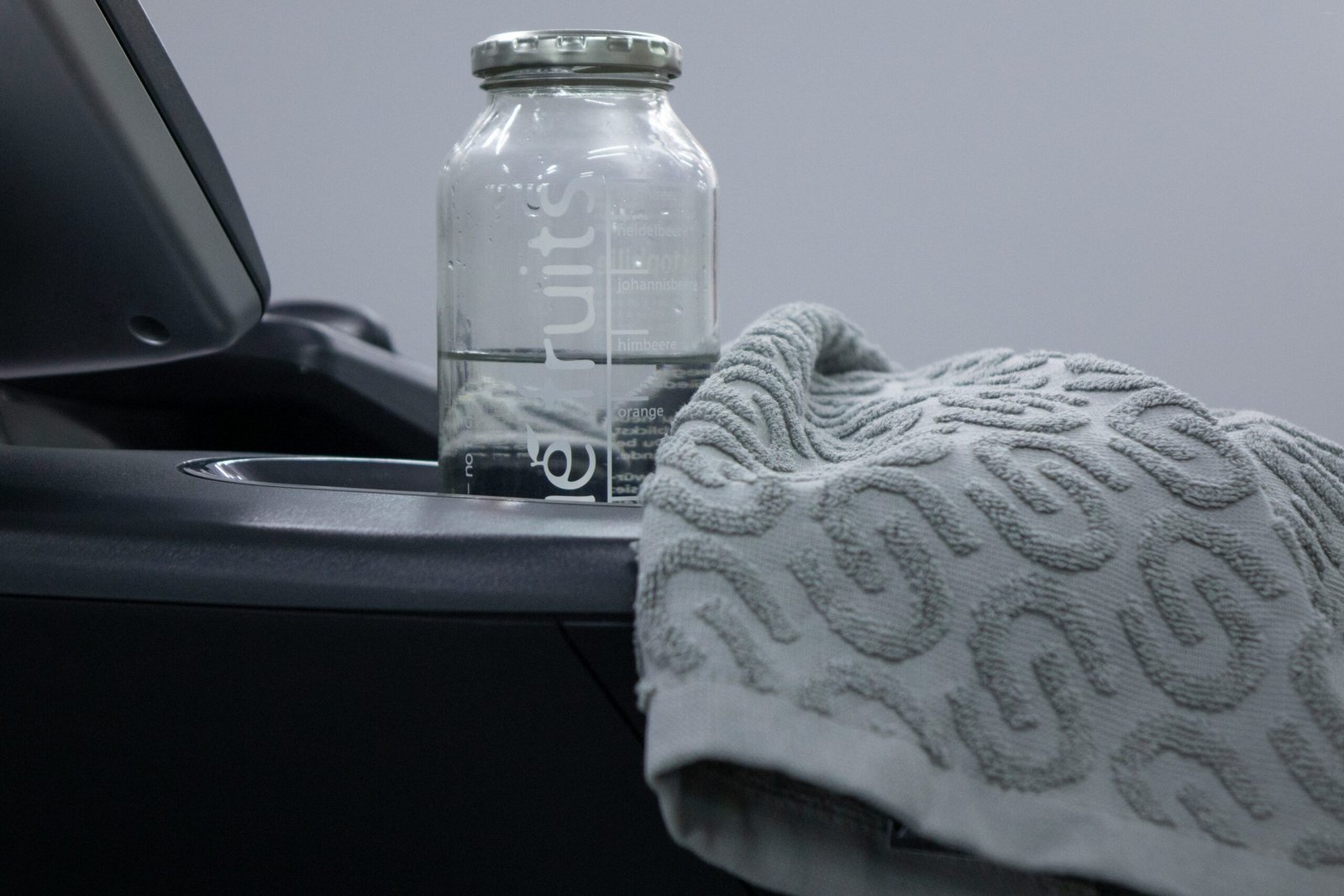 a bottle of water sitting next to a towel